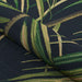 Couristan Dolce Indoor/Outdoor Rug - Bamboo Forest/Cool Onyx is shown partially rolled