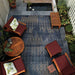 Couristan Dolce Indoor/Outdoor Rug - Blue Nile/Indigo is beautifully laid out on a patio under wooden furniture