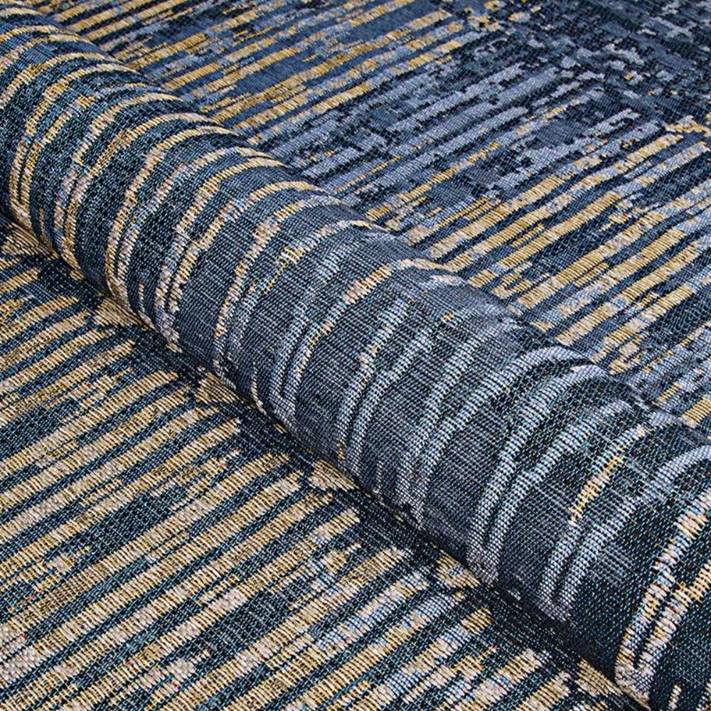 Couristan Dolce Indoor/Outdoor Rug - Blue Nile/Indigo is partially rolled