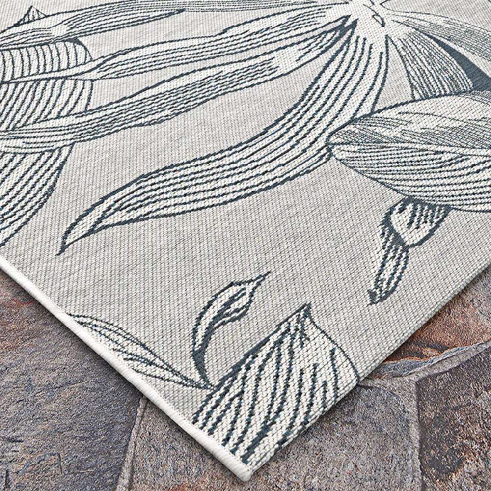 Couristan Dolce Indoor/Outdoor Rug - Flora/Argento features a detailed floral design with sweeping lines and petals