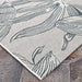 Couristan Dolce Indoor/Outdoor Rug - Flora/Argento features a detailed floral design with sweeping lines and petals