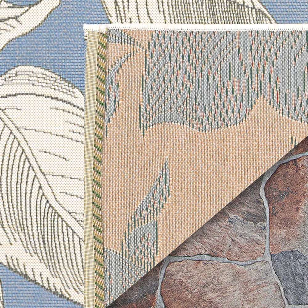 Couristan Dolce Indoor/Outdoor Rug - Flora/Ice is shown up close with a corner flipped over to reveal the beige and gray underside and its fine woven texture
