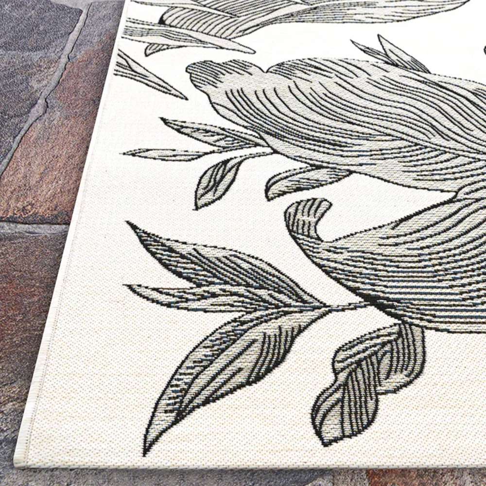 Couristan Dolce Indoor/Outdoor Rug - Flora/Snow is angled in a corner view