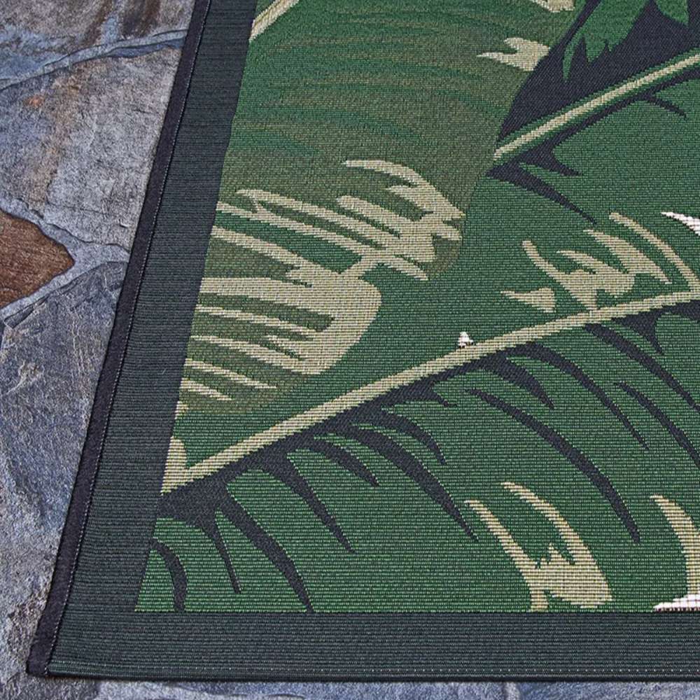 Couristan Dolce Indoor/Outdoor Rug - Palm Lily/Hunter Green-Ivory highlights its tight weave and vibrant leaf design in green and tan