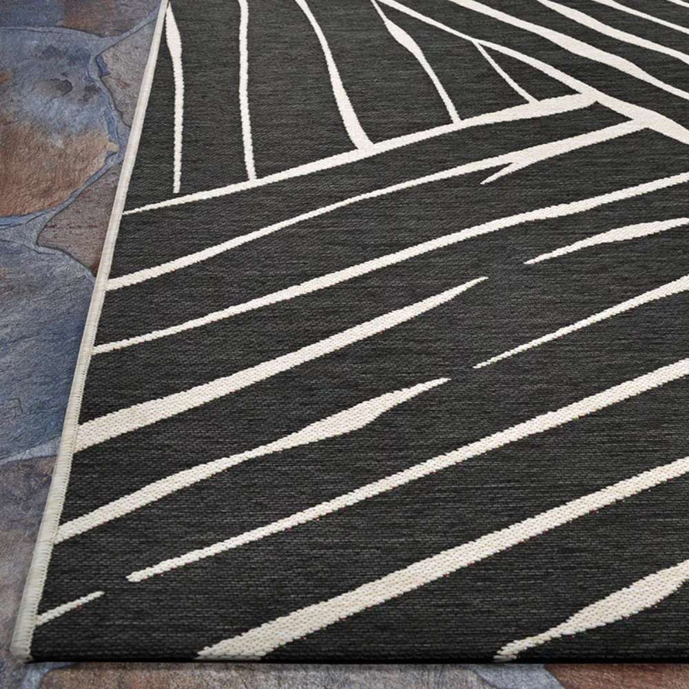 Couristan Dolce Indoor/Outdoor Rug - Parquet/Charcoal displays its crisp linear pattern along the edge in a close-up view