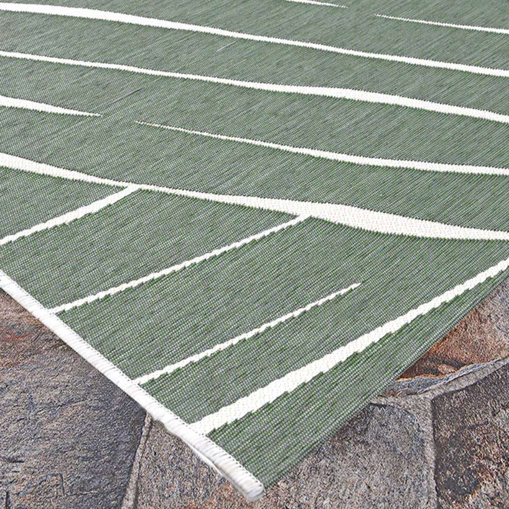 Couristan Dolce Indoor/Outdoor Rug - Parquet/Fern lies flat on stone tiles