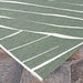 Couristan Dolce Indoor/Outdoor Rug - Parquet/Fern lies flat on stone tiles