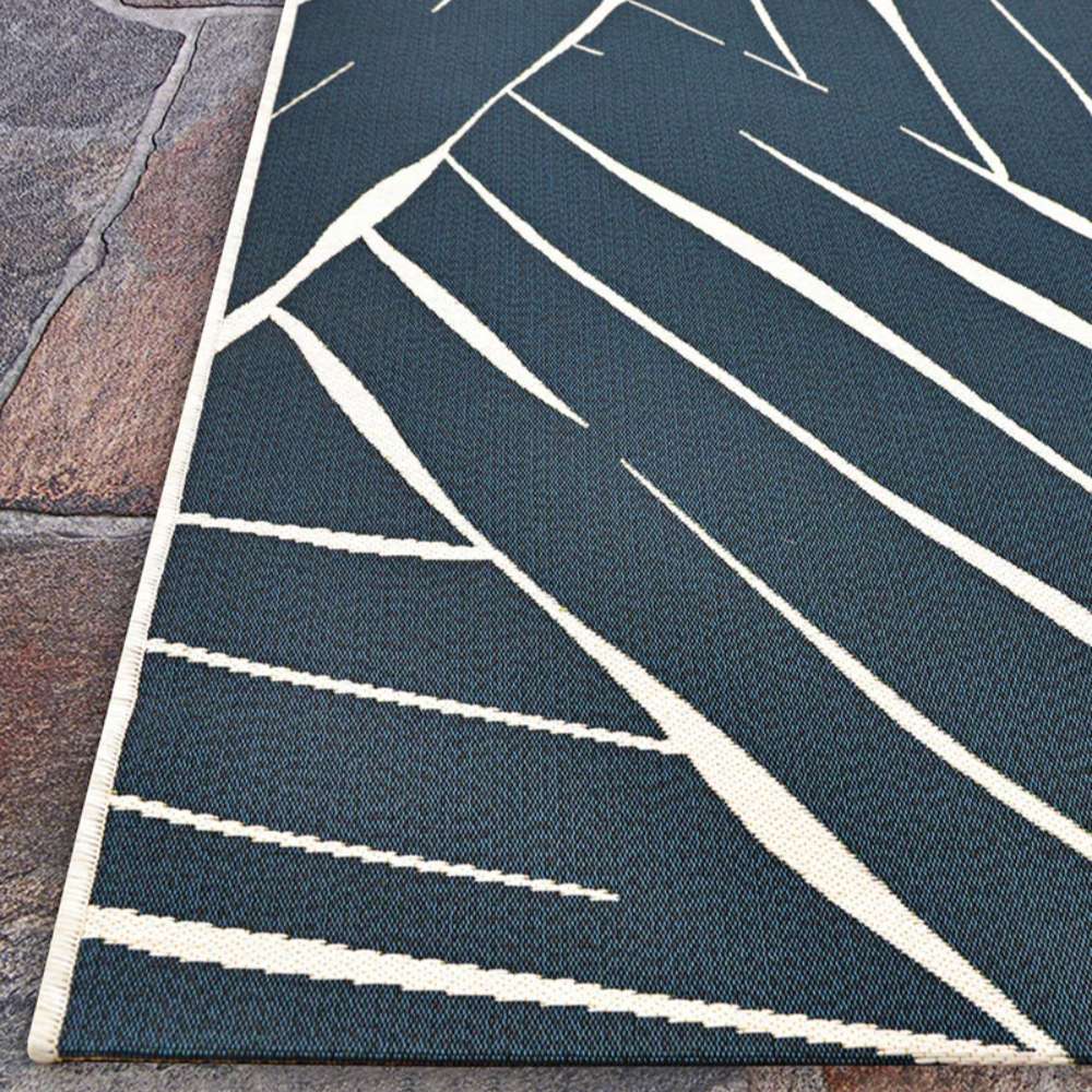Couristan Dolce Indoor/Outdoor Rug - Parquet/Ink features sharp, angular ivory lines on an ink-blue background in a modern zigzag pattern