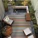 Couristan Dolce Indoor/Outdoor Rug - Striped/Sunset enhances a cozy backyard seating area with warm, multicolored stripes adding a bold focal point