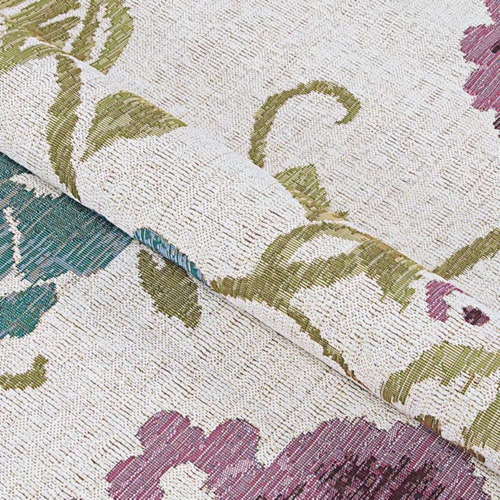 Couristan Dolce Indoor/Outdoor Rug - Tivoli/Ivory-Multi is gently folded to show its soft texture and intricate floral patterns in green, purple, and teal