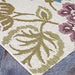 Couristan Dolce Indoor/Outdoor Rug - Tivoli/Ivory-Multi lies flat on a stone surface, displaying leafy green and purple floral patterns on an ivory background
