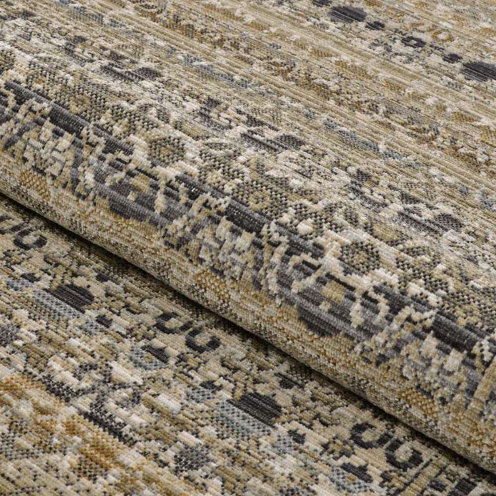 Couristan Fez Indoor/Outdoor Rug - Medina/Earthen is partially rolled to showcase its flexible construction and intricate pattern work
