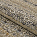 Couristan Fez Indoor/Outdoor Rug - Medina/Earthen is partially rolled to showcase its flexible construction and intricate pattern work
