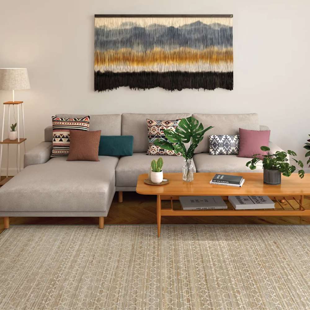 Couristan Fez Indoor/Outdoor Rug - Riad/Sand is laid out in a modern living room under a beige sectional sofa and wooden coffee table