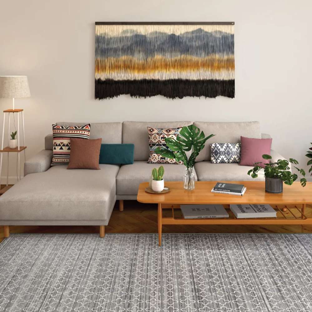 Couristan Fez Indoor/Outdoor Rug - Riad/Tobacco is displayed in a modern living room under a beige sectional sofa, wooden table, and decorative plants