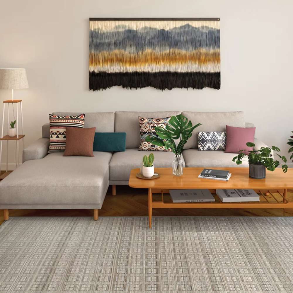 Couristan Fez Indoor/Outdoor Rug - Sidi/Sunlight is shown in a cozy living room under a sectional sofa and wooden coffee table