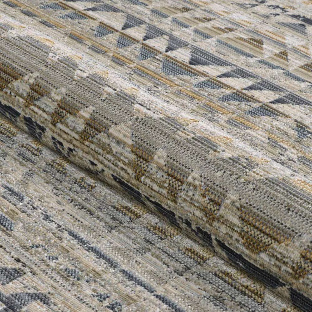 Couristan Fez Indoor/Outdoor Rug - Souk/Earthen is shown partially rolled to display its flexible weave and geometric design