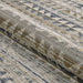 Couristan Fez Indoor/Outdoor Rug - Souk/Earthen is shown partially rolled to display its flexible weave and geometric design