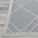 Couristan Liguria Indoor/Outdoor Rug - Noli/Azul displays its elegant edge and ivory-trimmed border lying flat on a wooden floor