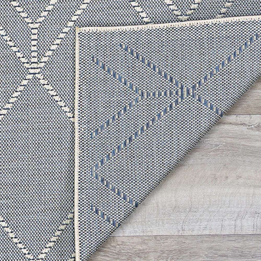 Couristan Liguria Indoor/Outdoor Rug - Noli/Azul is shown flipped at the corner revealing its sturdy and reversible weave