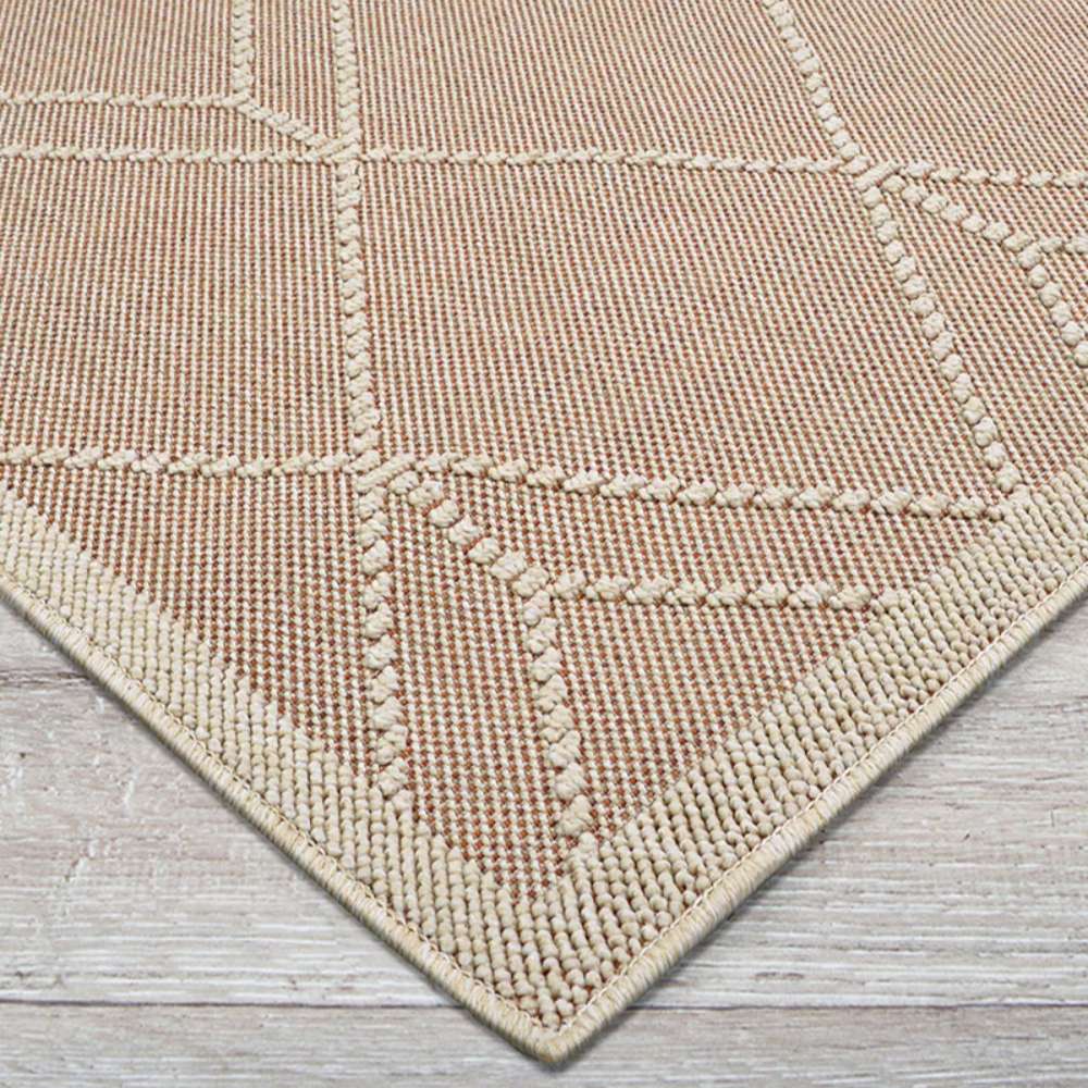 Couristan Liguria Indoor/Outdoor Rug - Noli/Umber corner view highlights its ivory binding and raised diamond-pattern details
