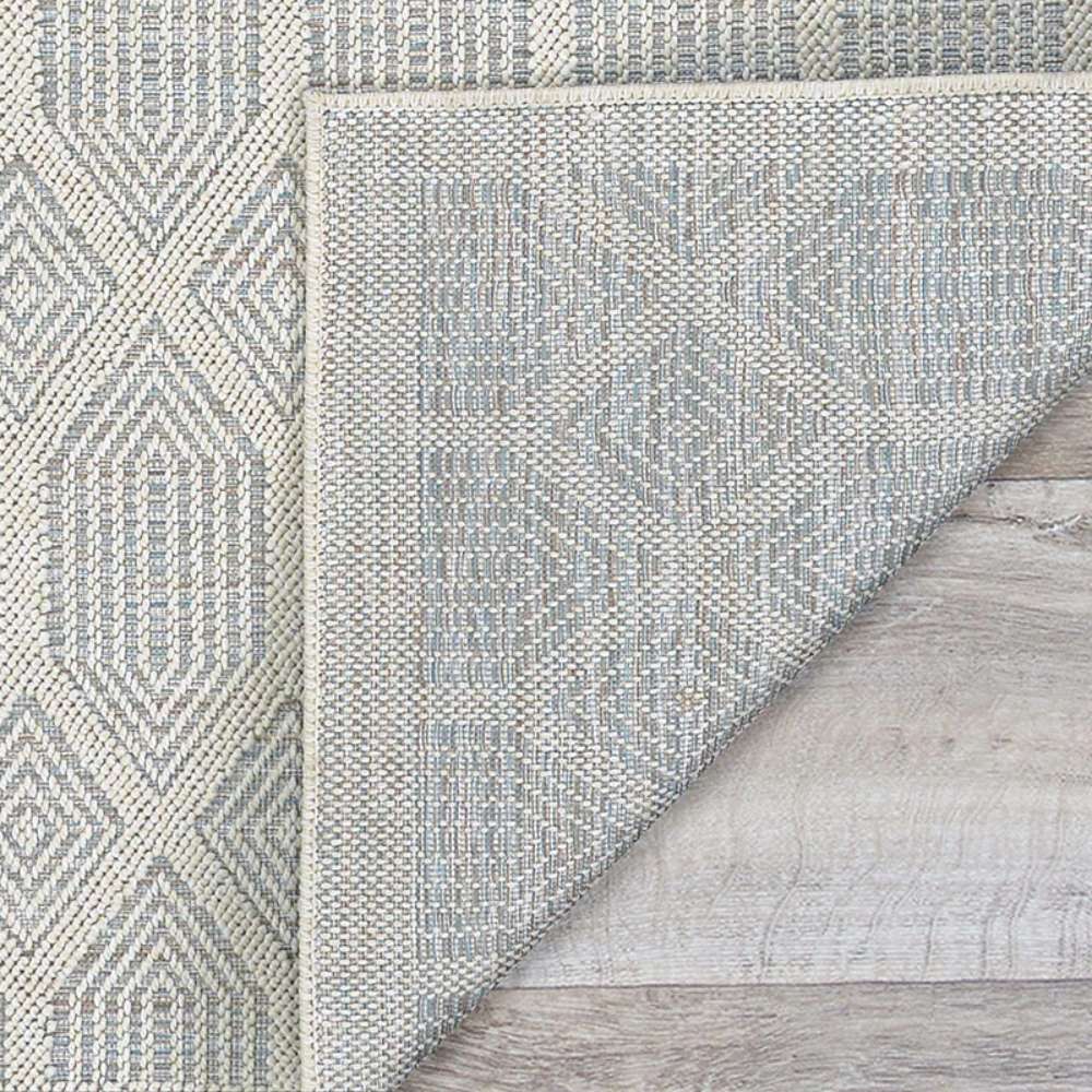 Couristan Liguria Indoor/Outdoor Rug - Rapallo/Aqua is shown flipped at the corner to reveal its tightly woven backing