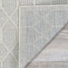 Couristan Liguria Indoor/Outdoor Rug - Rapallo/Aqua is shown flipped at the corner to reveal its tightly woven backing