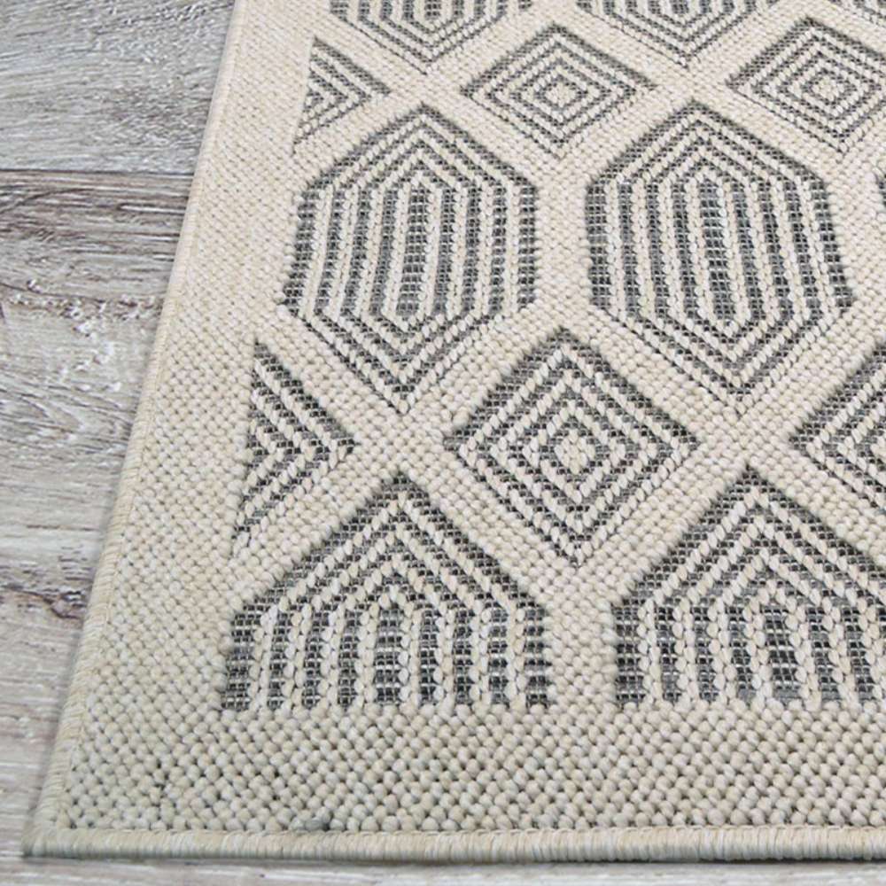 Couristan Liguria Indoor/Outdoor Rug - Rapallo/Pebble is pictured with a focus on its corner emphasizing the clean stitching and raised pattern