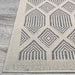 Couristan Liguria Indoor/Outdoor Rug - Rapallo/Pebble is pictured with a focus on its corner emphasizing the clean stitching and raised pattern