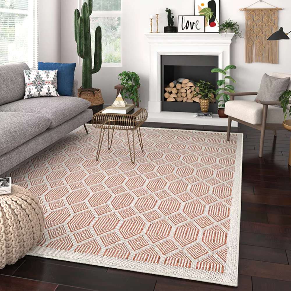 Couristan Liguria Indoor/Outdoor Rug - Rapallo/Umber is placed in a modern living room with neutral furniture, plants, and a fireplace