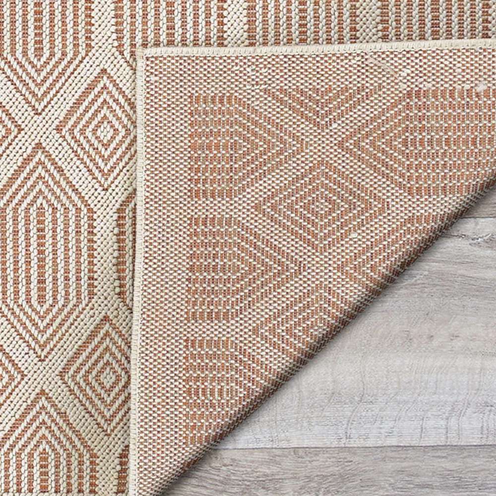 Couristan Liguria Indoor/Outdoor Rug - Rapallo/Umber shows its underside corner folded over revealing the same diamond pattern in reverse