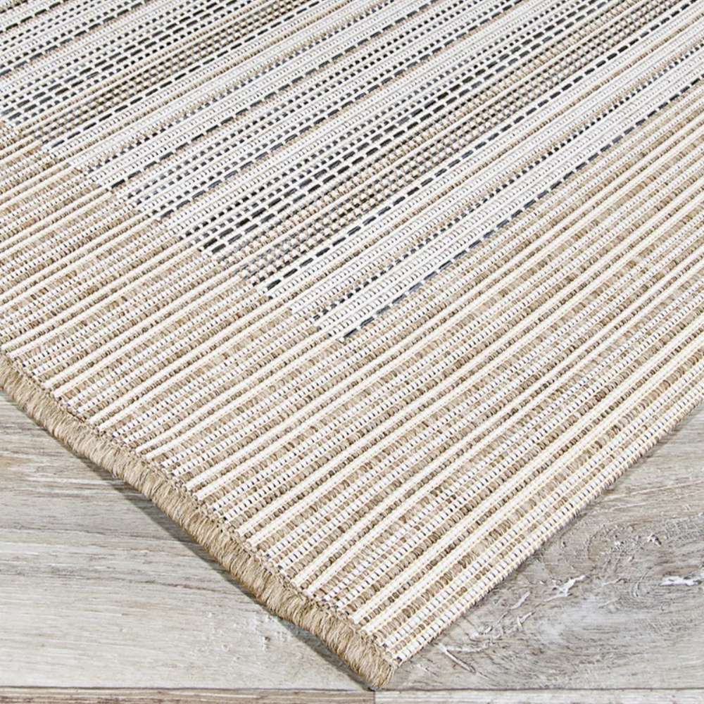 Couristan Monaco Indoor/Outdoor Rug - Bowline/Cocoa Natural-Ivory displays its neat striped edge lying flat on a wooden floor