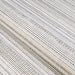 Couristan Monaco Indoor/Outdoor Rug - Bowline/Cocoa Natural-Ivory is shown folded emphasizing its flexible and durable woven design