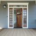 Couristan Monaco Indoor/Outdoor Rug - Bowline/Cocoa Natural-Ivory sits on a porch entryway