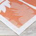 Couristan Monaco Indoor/Outdoor Rug - Coastal Flora/Ivory-Orange displays a detailed corner design