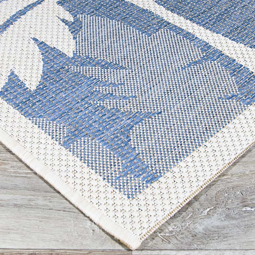 Couristan Monaco Indoor/Outdoor Rug - Coastal Flora/Ivory-Sapphire corner view highlights its sturdy weave and subtle blue-and-ivory design