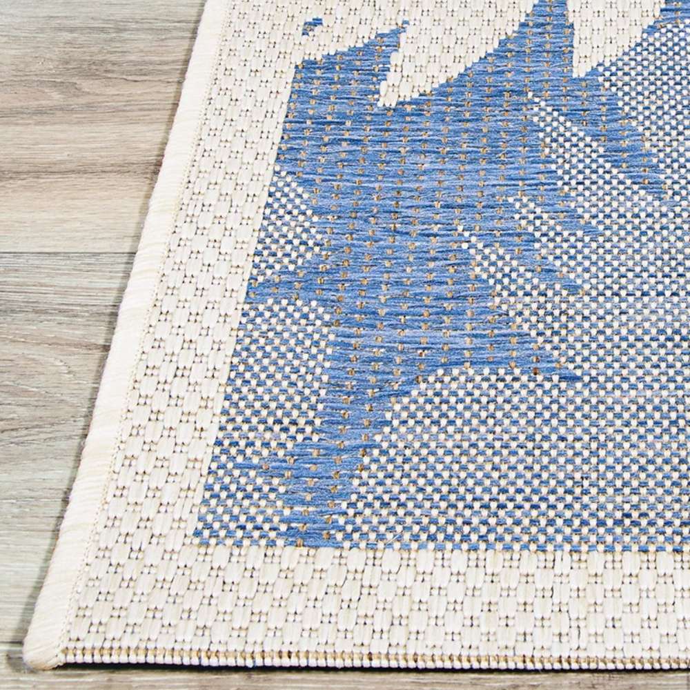 Couristan Monaco Indoor/Outdoor Rug - Coastal Flora/Ivory-Sapphire displays a crisp ivory border framing its botanical sapphire pattern