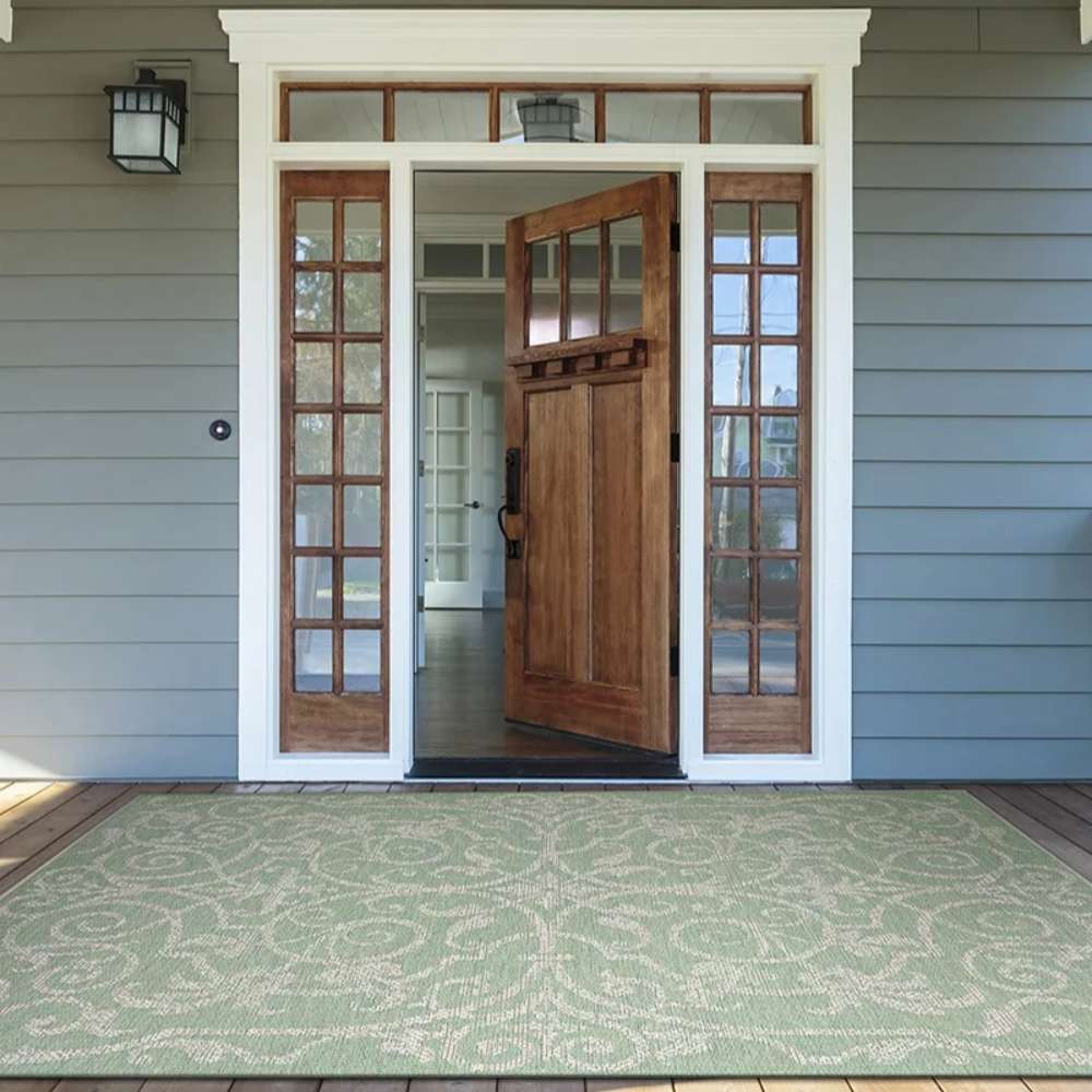 Couristan Monaco Indoor/Outdoor Rug - Summer Quay/Ivory-Light Green lies at a front door entryway