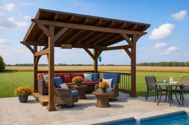 Cozy patio furniture with red cushions under the Brookside Timber Frame Ridgeview Pavilion beside a pool