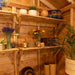Cozy shed corner displays Outdoor Living Today 8ft Western Red Cedar Shed Shelves (Set of 3) holding potted plants, baskets, and decorative items