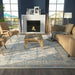 Cozy living room with a fireplace features Momeni Anatolia Indoor Rug - ANA-8 Blue