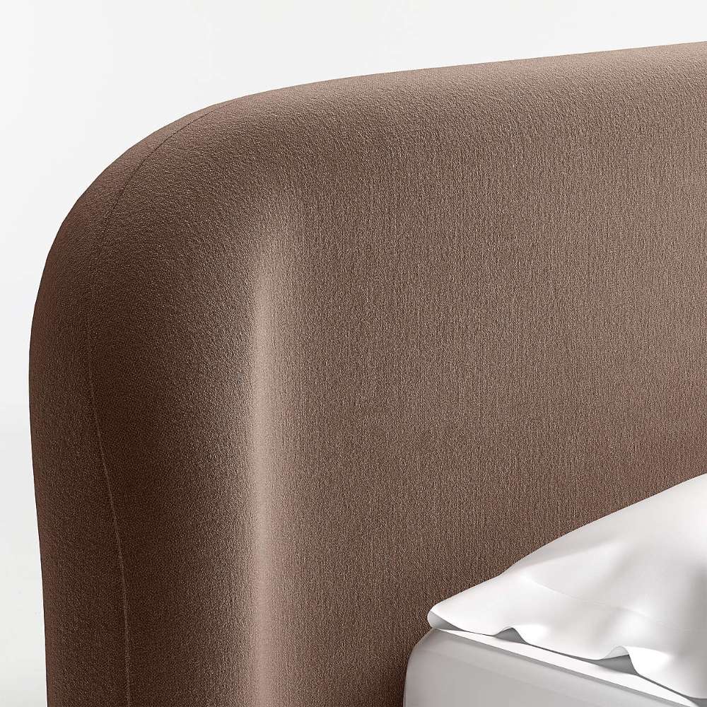 Crate & Barrel Adelaide Curved Upholstered Bed close-up highlighting the curved upholstered headboard with a smooth rounded edge