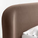 Crate & Barrel Adelaide Curved Upholstered Bed close-up highlighting the curved upholstered headboard with a smooth rounded edge