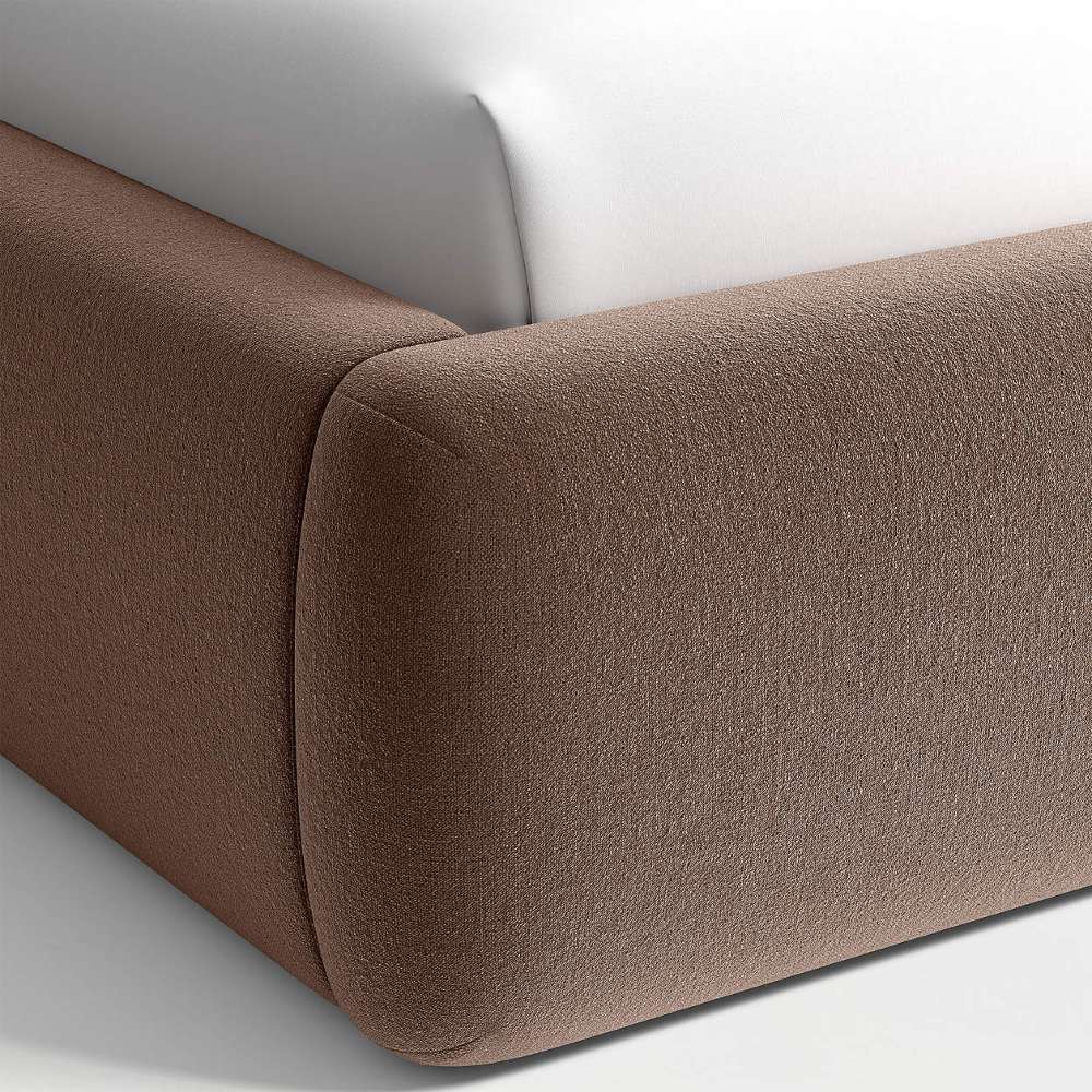 Crate & Barrel Adelaide Curved Upholstered Bed close-up showing the rounded upholstered footboard corner and soft fabric texture