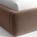 Crate & Barrel Adelaide Curved Upholstered Bed close-up showing the rounded upholstered footboard corner and soft fabric texture
