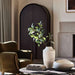 Crate & Barrel Annie 38" Charcoal Brown Storage Cabinet styled in a living room behind a coffee table with decorative vases and greenery