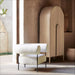Crate & Barrel Annie 38" Natural Storage Cabinet styled beside a modern accent chair in a warm, contemporary space