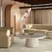 Crate & Barrel Annie 38" Natural Storage Cabinet styled in a living room with curved seating and a round stone coffee table
