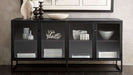 Crate & Barrel Casement 66" Black Credenza displays decorative bowls, books, and accents on two shelves behind smoked glass doors