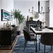 Crate & Barrel Casement 66" Black Credenza serves as a stylish dining room sideboard, holding barware and decorative accents beside a dining table